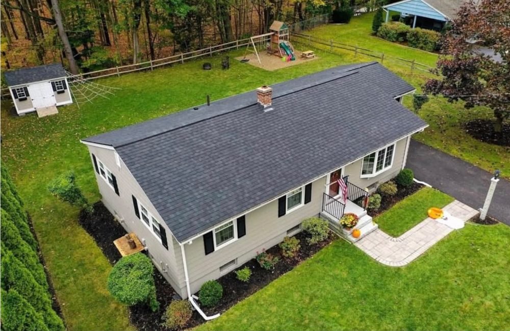Shingle roof replacement on ranch home, aerial view by Hawks Roofing